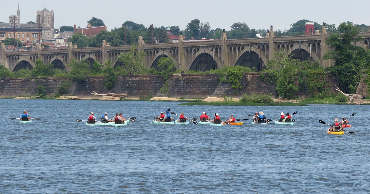 Riverfest image kayakers with bridge in background